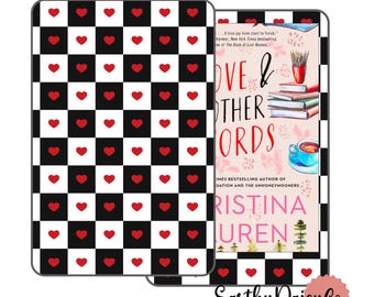 May include: A black and white checkered Kindle cover with red hearts. The cover is next to a book with the title "Love & Other Words" by Christina Lauren. The book cover has a floral design and a teacup.