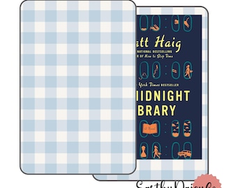May include: A blue and white gingham book cover with a dark blue book spine featuring the title "Midnight Library" by Matt Haig. The book cover has a yellow and orange illustration of a clock and a person walking.