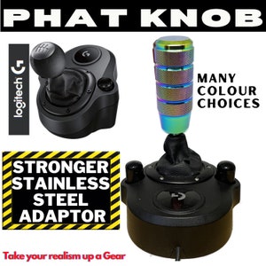 May include: A black Logitech G shifter with a black leather gear knob and a rainbow coloured metal gear stick extension. The text "PHAT KNOB" is at the top of the image. The text "STRONGER STAINLESS STEEL ADAPTOR" is in a yellow and black striped box. The text "MANY COLOUR CHOICES" is in the upper right corner of the image. The text "Take your realism up a Gear" is at the bottom of the image.