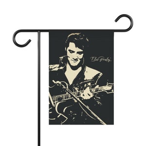 Elvis Presley. Elvis Presley in concert playing guitar in black and white Garden & House Banner or flag with his signature vintage look.