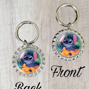 May include: Double-sided keychain featuring a blue cartoon character with large ears, holding a yellow object. The front side says "Front" and the back side says "Back".