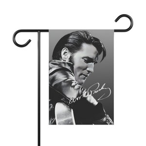 Elvis Presley. Elvis Presley in concert playing guitar in black and white Garden & House Banner or flag with his signature.