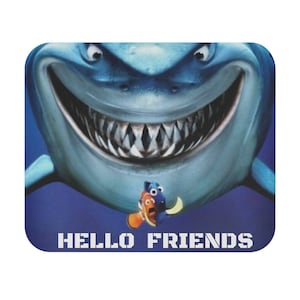 May include: A blue shark with a large, toothy grin, with a small orange and blue fish swimming in front of it. The text "HELLO FRIENDS" is printed below the shark.