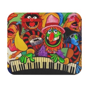 May include: A colorful illustration of a band of five muppets playing musical instruments. The muppets are wearing colorful clothing and hats. The muppet in the center is playing a keyboard. The muppet on the left is playing a guitar. The muppet on the right is playing a saxophone. The muppet in the back is playing a drum set. The muppet in the front is singing.