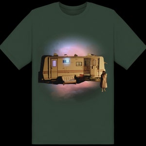 May include: A green t-shirt with a graphic of a white camper van with a couch inside and a woman standing in front of it. The camper van is floating in the air with a pink and purple glow behind it.