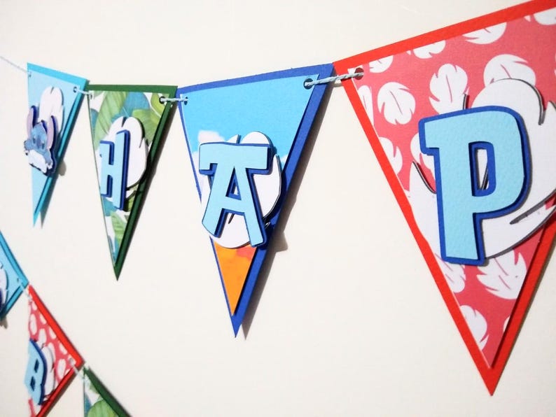May include: A blue and red banner with the word "Happy" spelled out in blue letters. Each letter is on a separate triangular flag. The flags are decorated with tropical patterns.