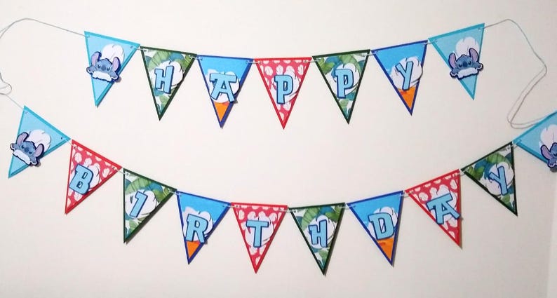 May include: A blue and green birthday banner with the words "Happy Birthday" in white letters. The banner features a cartoon character with blue fur and large ears.