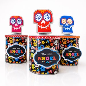 May include: Three decorative tins with a Day of the Dead design. Each tin has a colourful skull topper and a label that reads "ANGEL" in bright colours. The tins are decorated with floral and skull patterns.