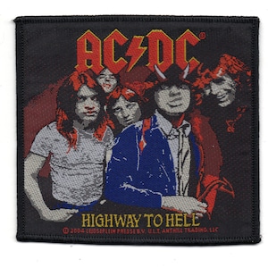 May include: A black and white patch featuring the band AC/DC's logo in yellow and red. The text "Highway to Hell" is printed below the logo. The band members are pictured in the background. The text "2004 LEIDSOPLEIN PRESSE BV. ULT ANTHILL TRADING LLC" is printed at the bottom.