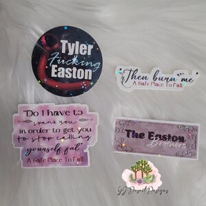 May include: A collection of stickers with various text designs. One sticker reads "Tyler Fucking Easton" in white text on a dark background. Other stickers include phrases like "Then burn me" and "Do I have to spank you".