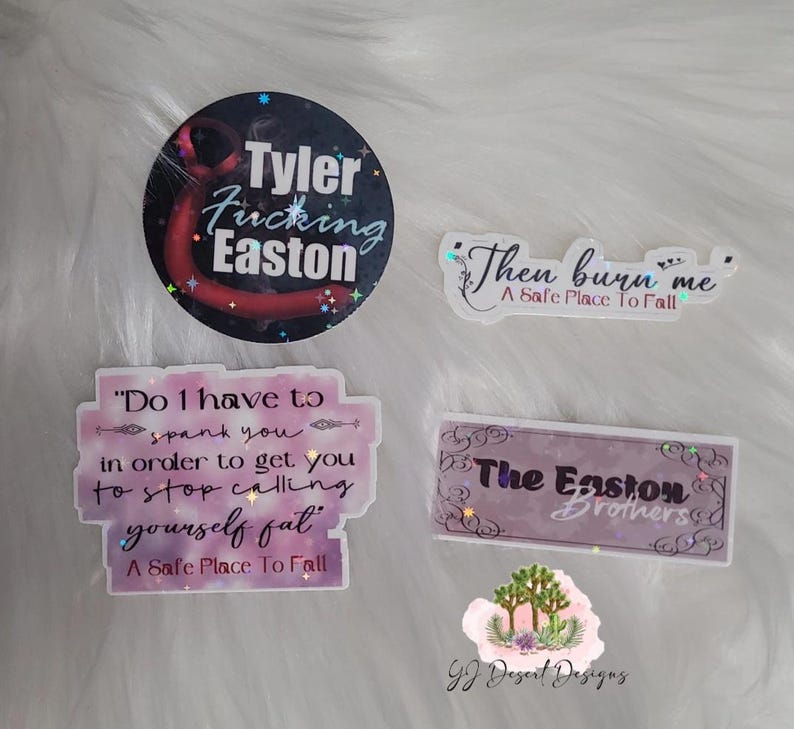 May include: A collection of stickers with various text designs. One sticker reads "Tyler Fucking Easton" in white text on a dark background. Other stickers include phrases like "Then burn me" and "Do I have to spank you".
