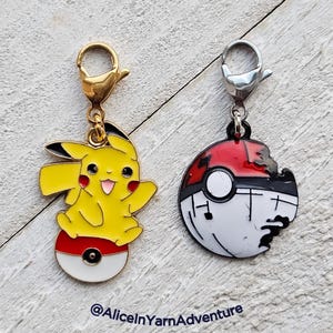 May include: Two gold and silver metal charms featuring Pokemon characters. The first charm is a yellow Pikachu standing on a red and white Pokeball. The second charm is a red, white, and black Pokeball with a bite taken out of it.  @AliceInYarnAdventure