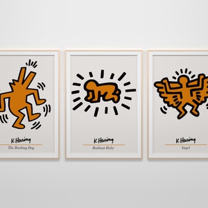May include: Three framed prints of black and white line drawings by artist K. Haring. The prints feature a barking dog, a radiant baby, and an angel. Each print has the artist's name and the title of the artwork.