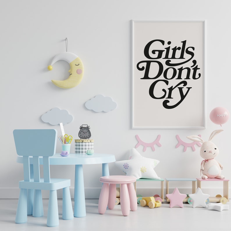Puede incluir: Un juego de mesa y silla para ni&ntilde;os de color azul claro con un taburete rosa. La mesa tiene un despertador negro y l&aacute;pices. Un p&oacute;ster enmarcado con el texto "Girls Don't Cry" est&aacute; en la pared. Tambi&eacute;n hay nubes, pesta&ntilde;as y un conejito de peluche en la pared.