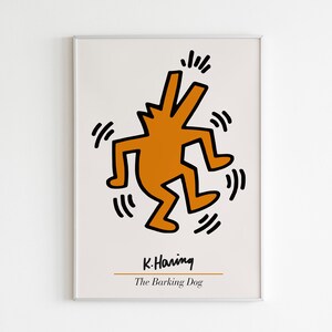 May include: A framed print of a black and white illustration of a dancing orange figure with the text "K. Haring" and "The Barking Dog" below the figure.