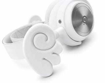 May include: White over-ear headphones featuring a circular metallic silver ear cup plate and a decorative white wing attachment on the headband. The headset includes a padded white headband and a small circular speaker grille on the side housing.