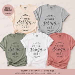 May include: Five short-sleeved crew neck t-shirts in light beige, heather gray, olive green, white, and dusty rose. Each shirt features a black graphic print with the text "YOUR design HERE" surrounded by decorative floral flourishes.