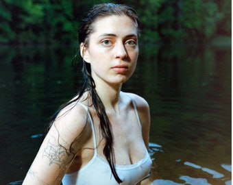 May include: Album cover art for the album "Older" by Lizzy McAlpine. The cover features a woman with wet hair, wearing a white tank top, submerged in a body of water. The album title "Older" is displayed at the top of the cover, and the artist's name "Lizzy McAlpine" is displayed in large, bold letters below the image. The album's tracklist is listed below the artist's name, along with the album's release year, number of songs, and total runtime.