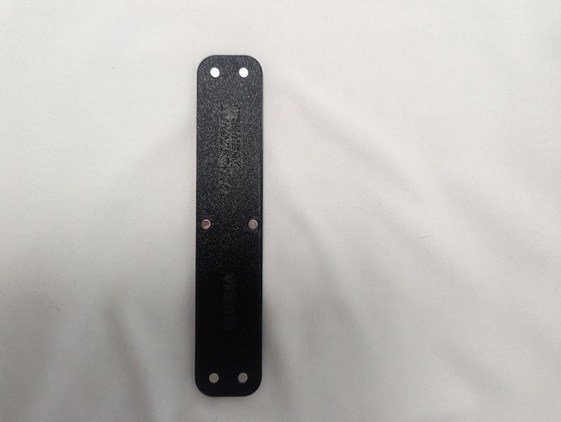 May include: Black leather wristband with four silver metal rivets.