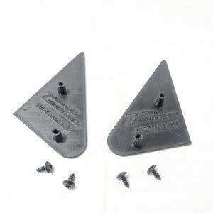 May include: Two black plastic triangle-shaped pieces with the text "Z-Axis Industries" and "Assembled in USA" on them. Four black screws are included.