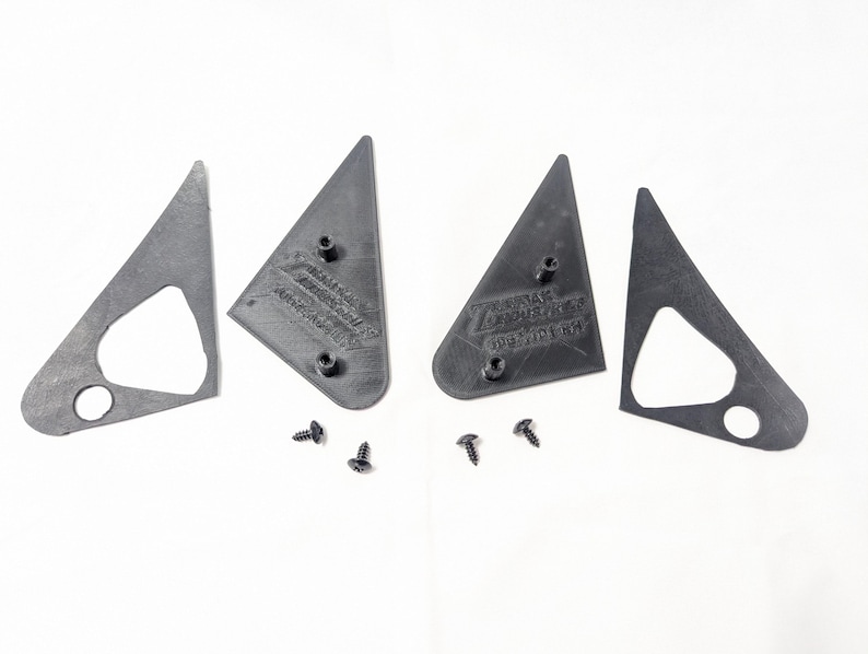 May include: Four black plastic pieces for a car's side view mirror, with two screws.