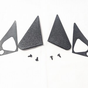 May include: Four black plastic triangular car mirror covers and four black screws.