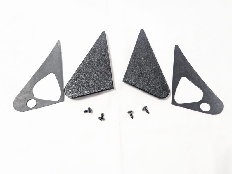 May include: Four black plastic triangular car mirror covers and four black screws.
