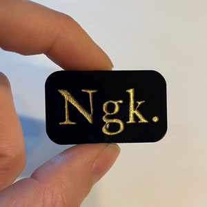 Ngk - engraved acrylic pin or magnet