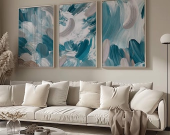 May include: A set of three vertical rectangular wall art pieces featuring abstract brushstrokes in shades of teal, white, and light gray. The paintings are displayed in thin, light-colored frames and arranged side-by-side on a neutral wall.
