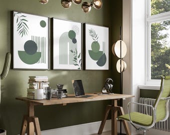 May include: An office space featuring a wooden desk with a laptop, books, and a green mesh chair. Three framed abstract art prints with green and white geometric designs hang above the desk. A modern light fixture and a floor lamp are also visible.