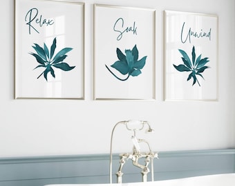 May include: Three framed prints with teal botanical illustrations and white text. The prints read "Relax", "Soak", and "Unwind". The prints are hanging above a white bathtub with a silver faucet.