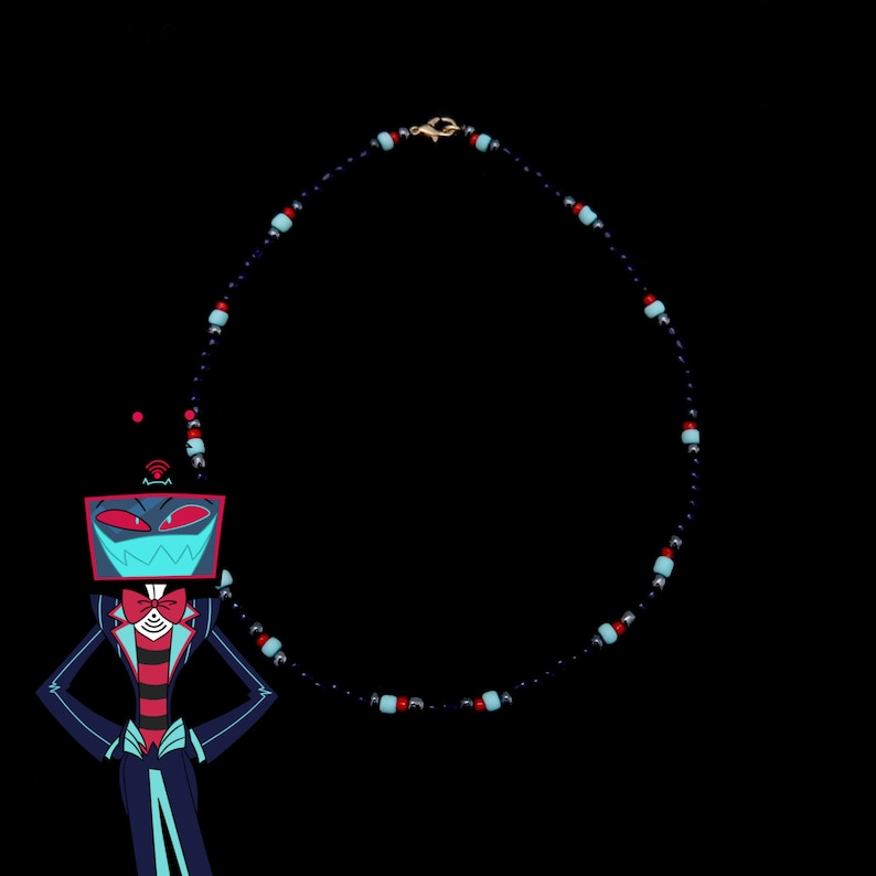 May include: A black necklace with blue and red beads. The necklace is in the shape of a circle and is hanging from a gold clasp. A cartoon character with a red and blue face is in the foreground.