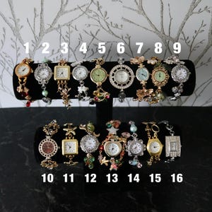Puede incluir: Diecis&eacute;is relojes de pulsera variados expuestos en un soporte en T negro, numerados del uno al diecis&eacute;is. La colecci&oacute;n presenta diversos acabados met&aacute;licos, incluidos tonos dorados y plateados, con variados dijes decorativos, cuentas y formas de esfera.