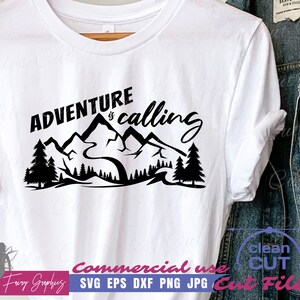 May include: White t-shirt with a black graphic of mountains, trees, and the phrase "Adventure is calling." The shirt is displayed next to a denim jacket. The design is suitable for outdoor enthusiasts.
