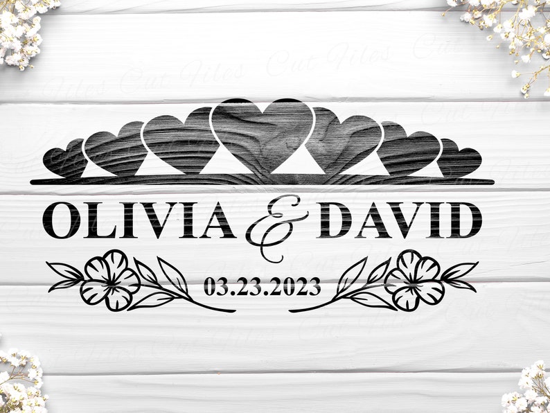 May include: Black and white wedding sign with a row of hearts and the names Olivia & David and the date 03.23.2023.