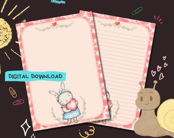 Pode incluir: Papelaria imprimível com fundo rosa e borda branca com corações. A papelaria tem um coelho bonito segurando um coração e um caracol com um coração na sua concha. O texto "DIGITAL DOWNLOAD" está no topo da página.