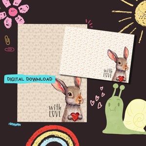 May include: Printable stationery featuring a brown bunny holding a red heart with the text "with love" on a beige background with a pattern of small pink hearts.