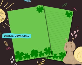 May include: Green printable lined paper with a shamrock border and a snail with a shell. The paper has the text "DIGITAL DOWNLOAD" on it.