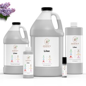 May include: Four bottles of Lilac scented oil from Jersey Botanical. The bottles are in various sizes, from a small roll-on bottle to a large gallon jug. The label on each bottle features a green leaf with a brown letter B inside, and the words "Jersey Botanical" and "Lilac".