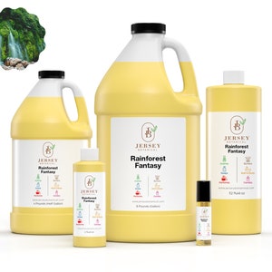May include: Four bottles of Rainforest Fantasy scented oil from Jersey Botanical. The bottles are in various sizes, from a small roll-on bottle to a large gallon jug. The label features a green and yellow rainforest scene with a waterfall.