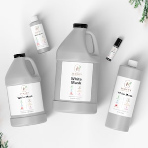 May include: Four bottles of White Musk essential oil from Jersey Naturals in different sizes: a 1 oz bottle, a 4 oz bottle, a 16 oz bottle, and a 32 oz bottle. The bottles are all gray and have a white label with the Jersey Naturals logo and the name of the scent.