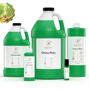 May include: Four bottles of China Rain essential oil in various sizes, from a small 4 fl oz bottle to a large 1 gallon jug. The bottles are green and feature a white label with the Jersey Botanical logo and the name "China Rain".