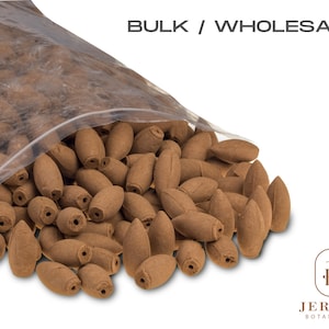 May include: A clear plastic bag filled with brown incense cones. The bag is open and the cones are spilling out. The text "BULK / WHOLESALE" is printed above the bag. The text "JERSEY BOTANICAL" is printed below the bag.