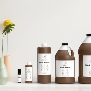 May include: Four brown bottles of essential oil with white labels and the text "Jersey Botanicals Black Women" on them. The bottles are arranged in a row from smallest to largest. The smallest bottle is a roll-on bottle. The largest bottle is a gallon size.