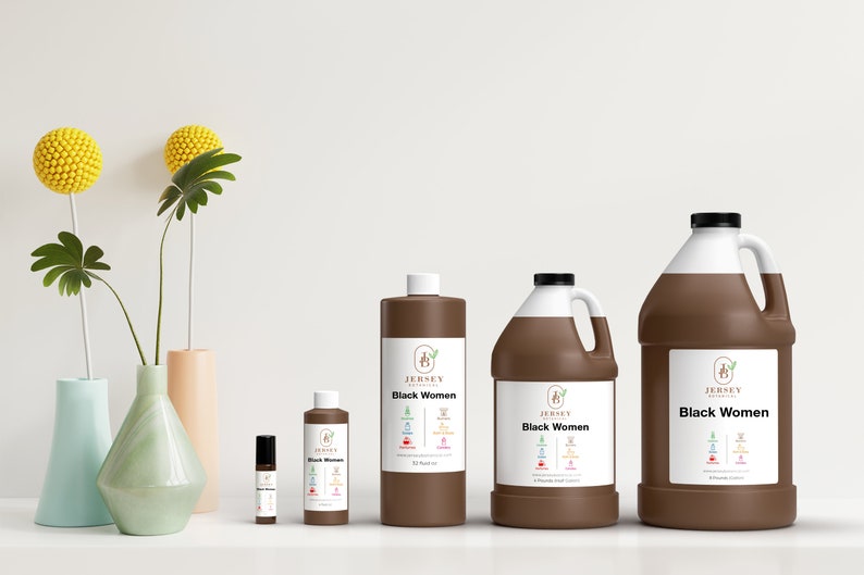 May include: Four brown bottles of essential oil with white labels and the text "Jersey Botanicals Black Women" on them. The bottles are arranged in a row from smallest to largest. The smallest bottle is a roll-on bottle. The largest bottle is a gallon size.