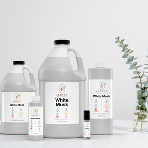 May include: Four bottles of White Musk fragrance oil in various sizes from Jersey Botanical. The bottles are white with black labels and the text "White Musk" is printed in black. The smallest bottle is a 1/2 oz roll-on, the next is a 2 oz bottle, the next is a 8 oz bottle, and the largest is a 32 oz bottle.