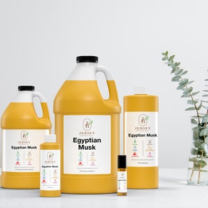 May include: Four bottles of Egyptian Musk essential oil in various sizes, from a small roller bottle to a large gallon jug. The bottles are all yellow and feature the Jersey Botanical logo and product name.