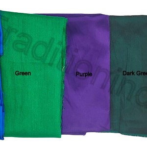 May include: Five fabric swatches in vibrant colors: blue, green, purple, dark green, and red. Each swatch is labeled with its respective color name in black text. The fabrics appear to be smooth and possibly silk or satin.
