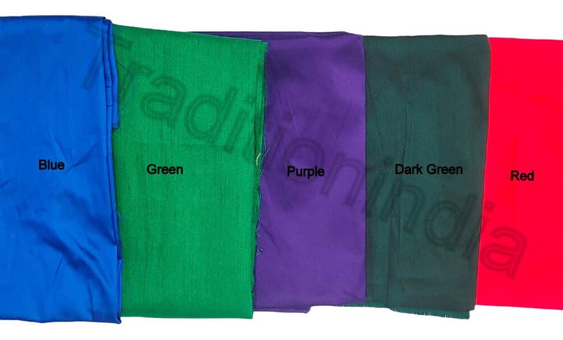 May include: Five fabric swatches in vibrant colors: blue, green, purple, dark green, and red. Each swatch is labeled with its respective color name in black text. The fabrics appear to be smooth and possibly silk or satin.
