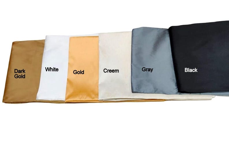 May include: A collection of fabric swatches in various colors, including dark gold, white, gold, cream, gray, and black. Each swatch is labeled with its respective color name in white text.